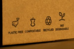 a cardboard box with the words 'plastic free', 'compostable', bio degradable' and recycled' on it.