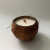 Half a coconut filled with coconut wax and a wooden wick
