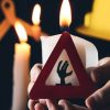 Why Candles Can Cause Fire, a safety sign on the front of a candle to advise on Stay Safe