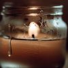 A candle jar is sweating. The wax inside is hot which is showing some candle sweating