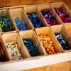 A box of used crayons with individual compartments for different colours. Can be used for adding colour to plain candles to turn into crayons, it is one idea about what to do with leftover candle wax.