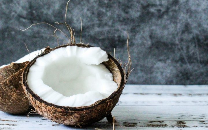 Discover the benefits of coconut candle wax as we have a coconut cut in half lying on a surface