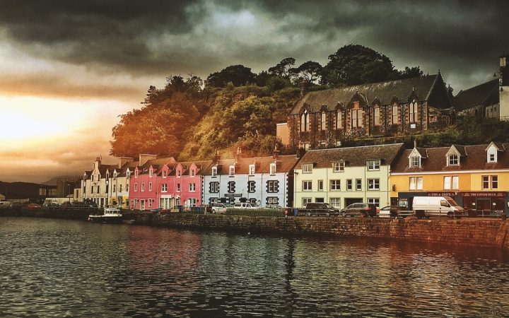 Colourful houses sit on front of the shore in Portree, the Isle fo Skye